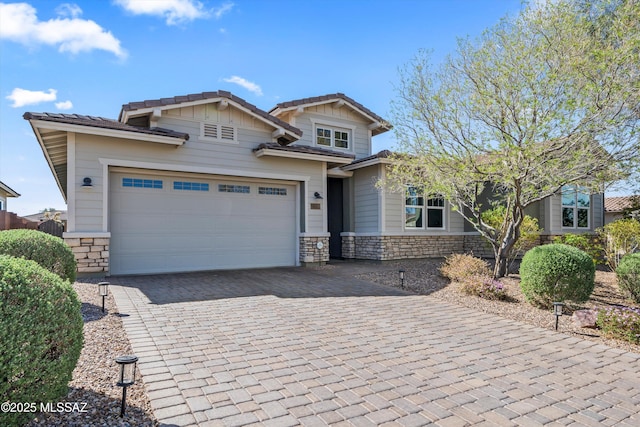 7415 W Cactus Flower Pass, Marana, AZ 85658 - view of front facade with stone siding, decorative driveway, a garage, and a tile roof