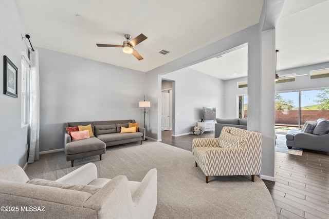 7415 W Cactus Flower Pass, Marana, AZ 85658 - living area featuring ceiling fan, wood finished floors, and baseboards