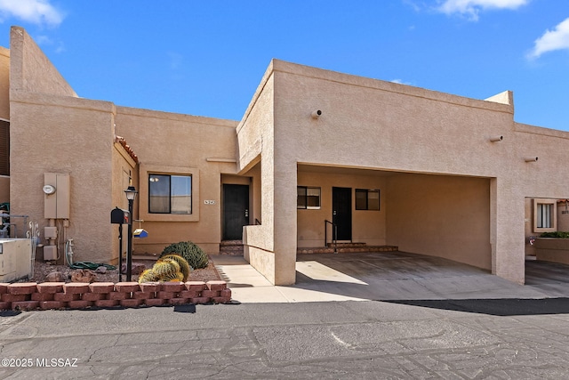 view of front of home featuring stucco siding and a garage