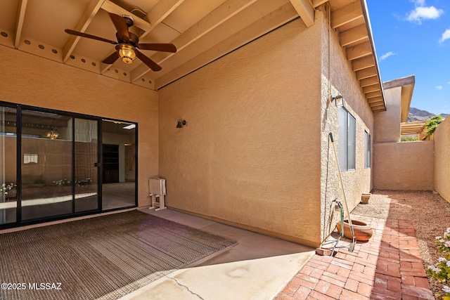 view of patio featuring fence and ceiling fan