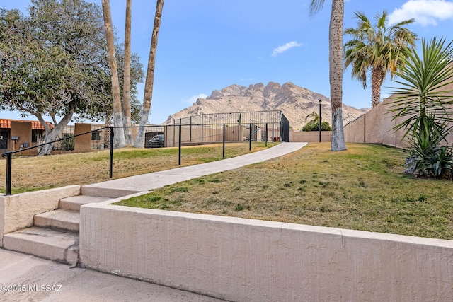 view of yard with a mountain view and fence