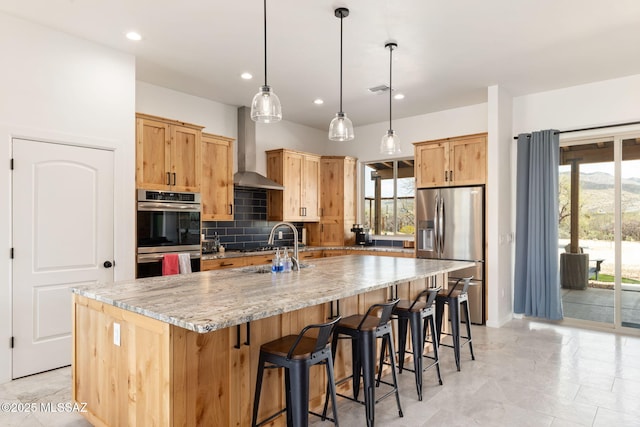 kitchen featuring decorative backsplash, wall chimney exhaust hood, a wealth of natural light, and stainless steel appliances