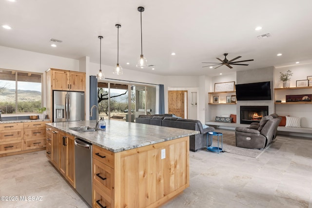 kitchen with light brown cabinets, appliances with stainless steel finishes, a sink, and visible vents