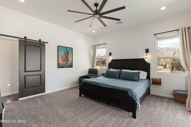 carpeted bedroom featuring recessed lighting, a barn door, visible vents, and baseboards