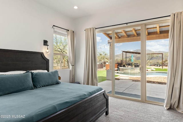 carpeted bedroom featuring recessed lighting, access to exterior, and a mountain view