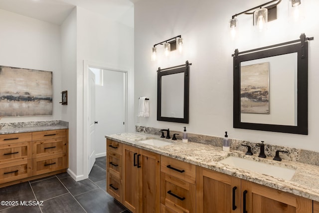 bathroom featuring tile patterned floors, double vanity, and a sink