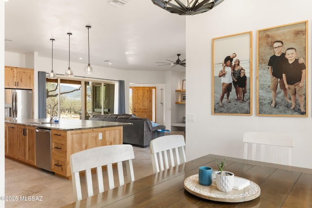 dining room featuring light wood-style flooring, ceiling fan, and visible vents