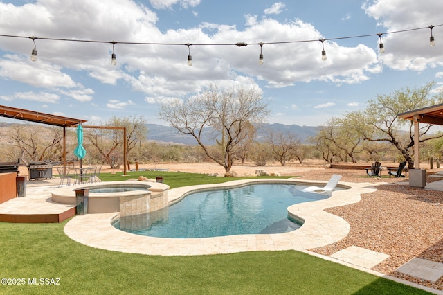 view of swimming pool with a patio, a mountain view, a grill, a pool with connected hot tub, and a lawn