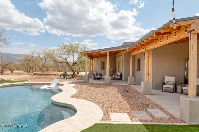 pool with a patio area and an outdoor hangout area