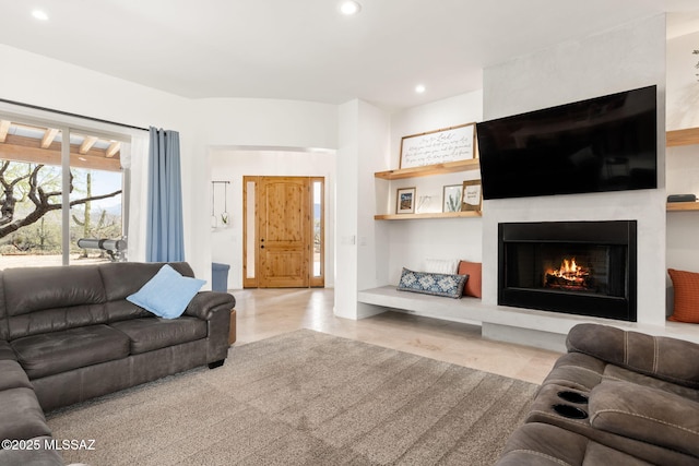 living room featuring a fireplace and recessed lighting