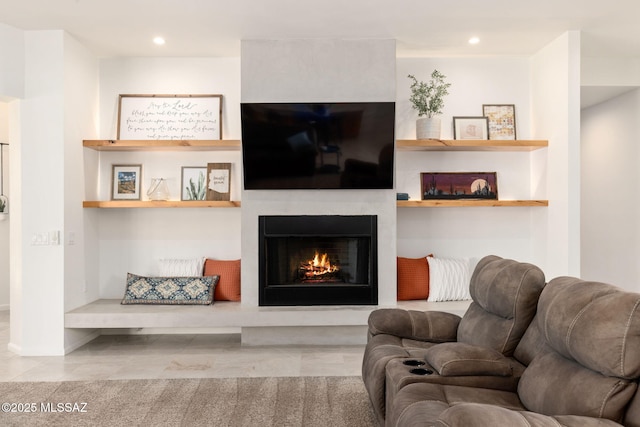 living room with built in features, a fireplace, and recessed lighting