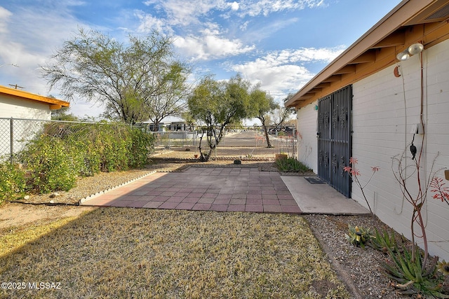 view of yard featuring fence and a patio area