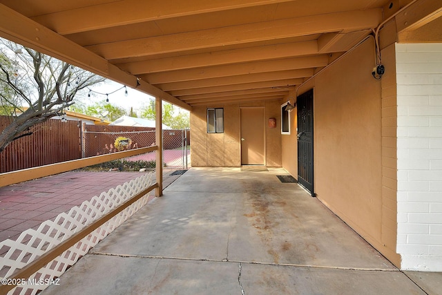 view of patio with a gate and fence