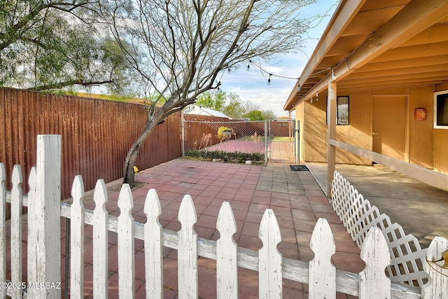 view of patio featuring a fenced backyard and a gate