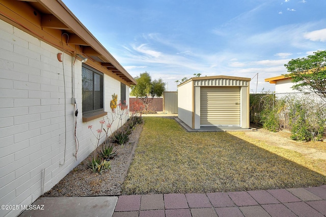 view of yard with a fenced backyard, an outbuilding, and a storage shed