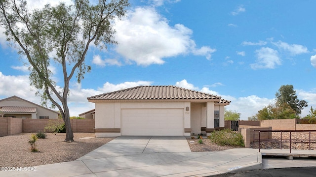 view of front of house with fence, a tiled roof, a garage, stucco siding, and driveway