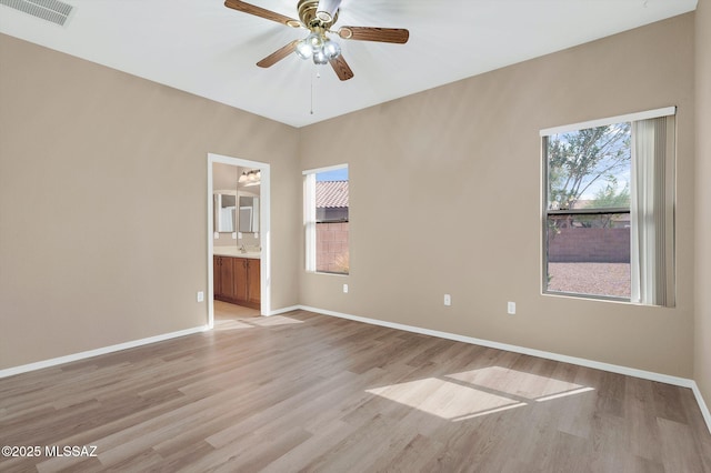 spare room featuring visible vents, a healthy amount of sunlight, and light wood finished floors