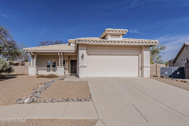 2525 N Camino Reloj, Green Valley, AZ 85614 - mediterranean / spanish-style house with a porch, a tile roof, stucco siding, and concrete driveway