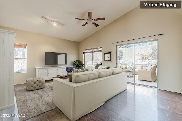 2525 N Camino Reloj, Green Valley, AZ 85614 - living room with rail lighting, a ceiling fan, high vaulted ceiling, wood finished floors, and baseboards