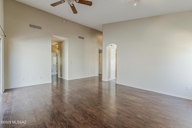 2525 N Camino Reloj, Green Valley, AZ 85614 - unfurnished room featuring ceiling fan, dark wood finished floors, high vaulted ceiling, and baseboards