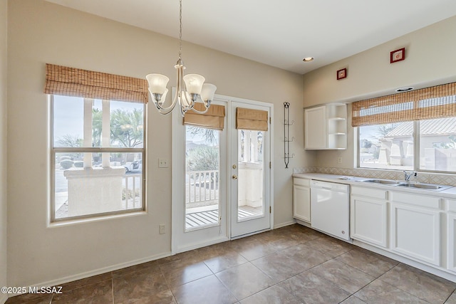 2525 N Camino Reloj, Green Valley, AZ 85614 - kitchen featuring white dishwasher, a sink, white cabinets, a chandelier, and decorative light fixtures