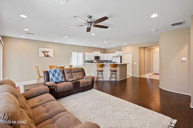 33743 S Ballad Dr, Red Rock, AZ 85145 - living room with dark wood-type flooring, ceiling fan, visible vents, and recessed lighting