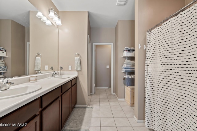 33743 S Ballad Dr, Red Rock, AZ 85145 - full bathroom featuring tile patterned flooring, double vanity, baseboards, and a sink