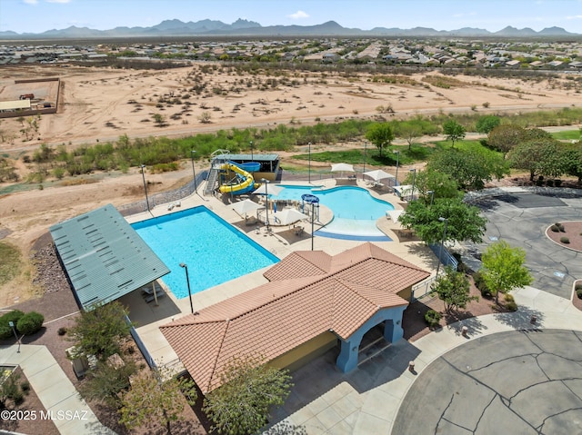 33743 S Ballad Dr, Red Rock, AZ 85145 - community pool featuring a patio area, a mountain view, a water play area, and a water slide