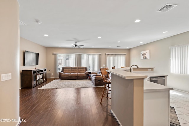 33743 S Ballad Dr, Red Rock, AZ 85145 - kitchen featuring visible vents, stainless steel dishwasher, plenty of natural light, and a kitchen bar