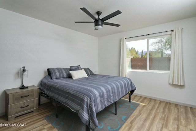2301 W Montrose Pl, Tucson, AZ 85741 - bedroom with baseboards, ceiling fan, and wood finished floors