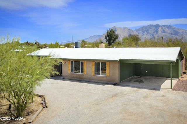 2301 W Montrose Pl, Tucson, AZ 85741 - view of front of house with driveway, a chimney, a carport, central air condition unit, and a mountain view