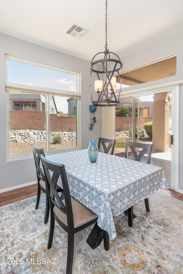 dining room with wood finished floors and a healthy amount of sunlight