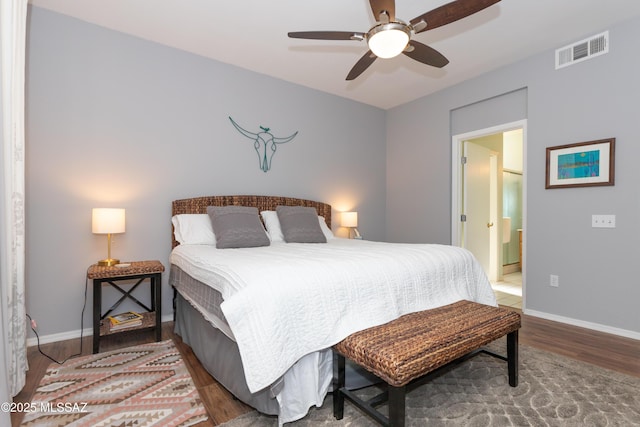 bedroom featuring ceiling fan, baseboards, visible vents, and wood finished floors