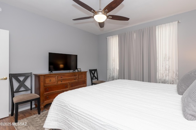 bedroom featuring wood finished floors and a ceiling fan