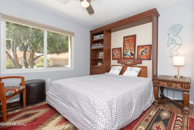 bedroom with visible vents, ceiling fan, and wood finished floors