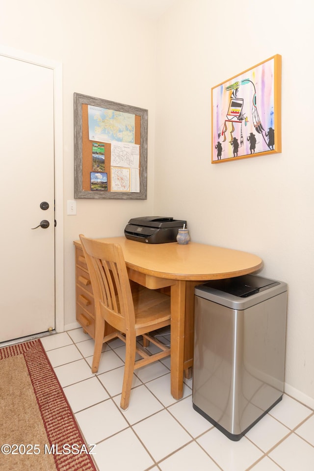 dining room featuring baseboards and light tile patterned floors