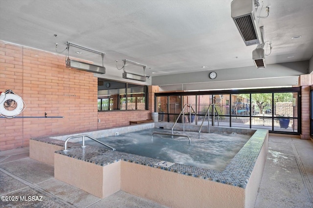 view of pool with an indoor hot tub