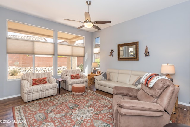 living area featuring plenty of natural light, baseboards, wood finished floors, and a ceiling fan