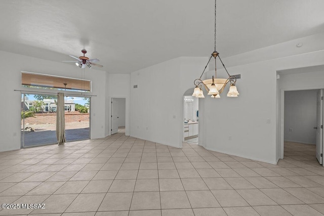 unfurnished room featuring visible vents, arched walkways, ceiling fan with notable chandelier, and light tile patterned flooring