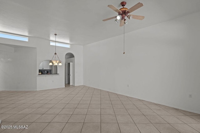 empty room with arched walkways and ceiling fan