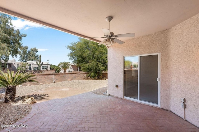 view of patio featuring fence and a ceiling fan