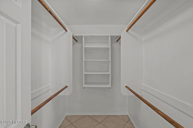 spacious closet featuring light tile patterned floors