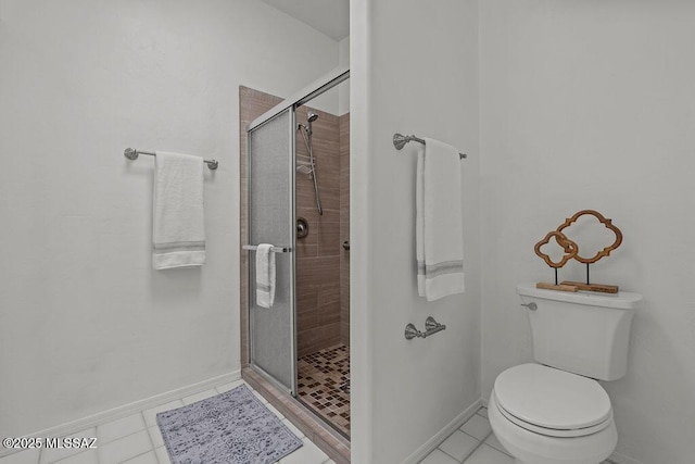 full bathroom with baseboards, a stall shower, toilet, and tile patterned flooring
