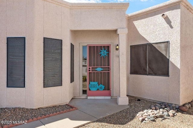 entrance to property with stucco siding