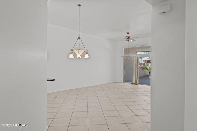 spare room featuring light tile patterned floors and ceiling fan with notable chandelier