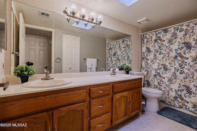 bathroom with double vanity, visible vents, and a sink