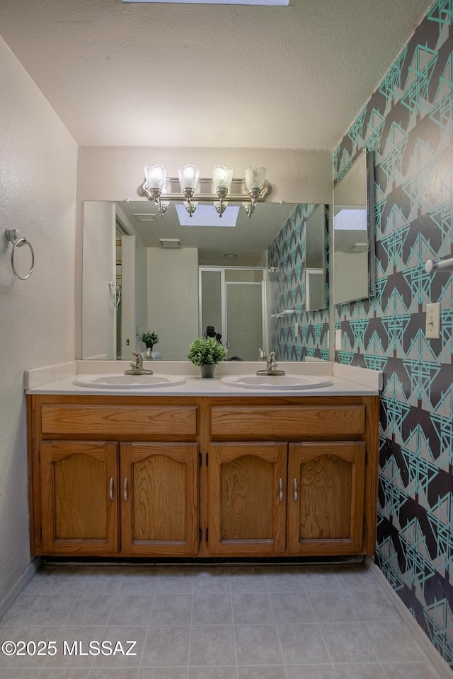 bathroom with double vanity, a sink, a chandelier, and a shower stall