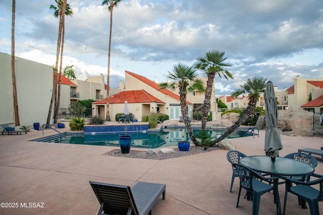 community pool with a patio area