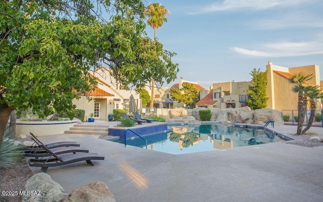 view of swimming pool with a fenced in pool, fence, and a patio