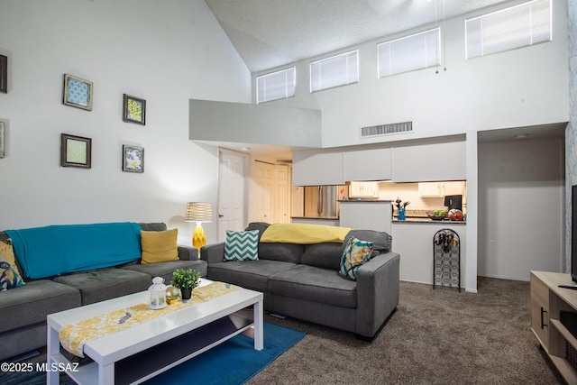 living area featuring visible vents, a towering ceiling, and carpet flooring